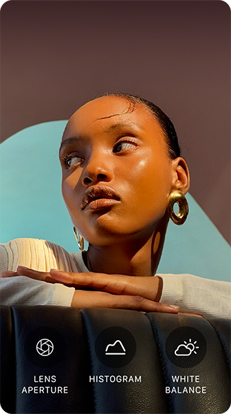A person with their head turned to the side, bright light shines on them from opposite direction, their hands overlapped on a flat surface in front of them at shoulder height, three photo controls: Lens Aperture, Histogram, and White Balance