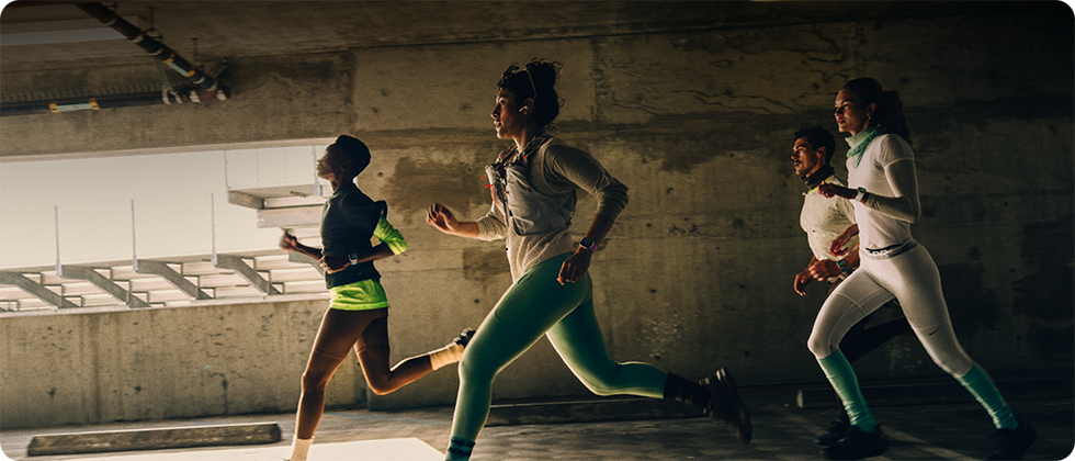 A group of people running in a city while wearing Apple Watch Series 12