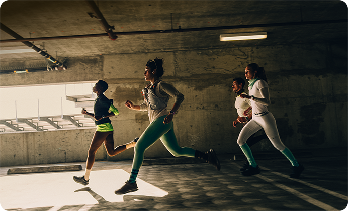 A group of people running in a city while wearing Apple Watch Series 12