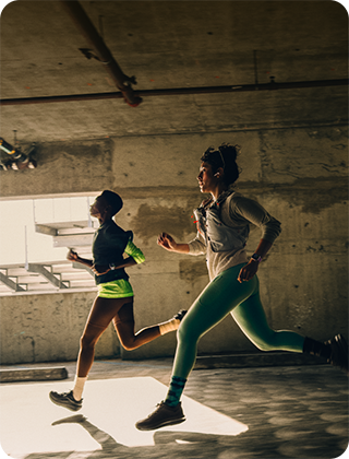 A group of people running in a city while wearing Apple Watch Series 12
