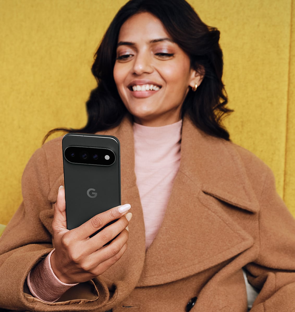 A woman holding a Pixel 11 Pro