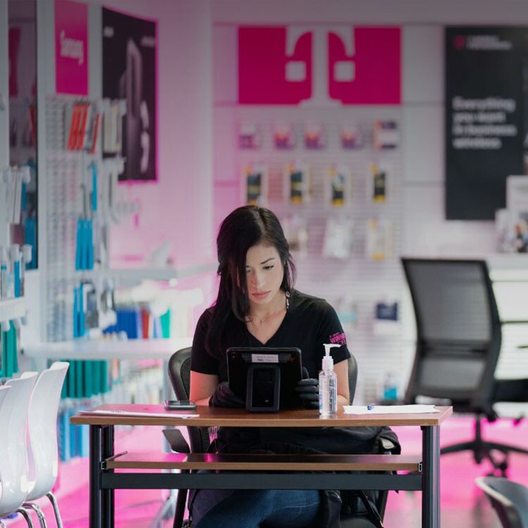 T-Mobile employee working in a T-Mobile retail store
