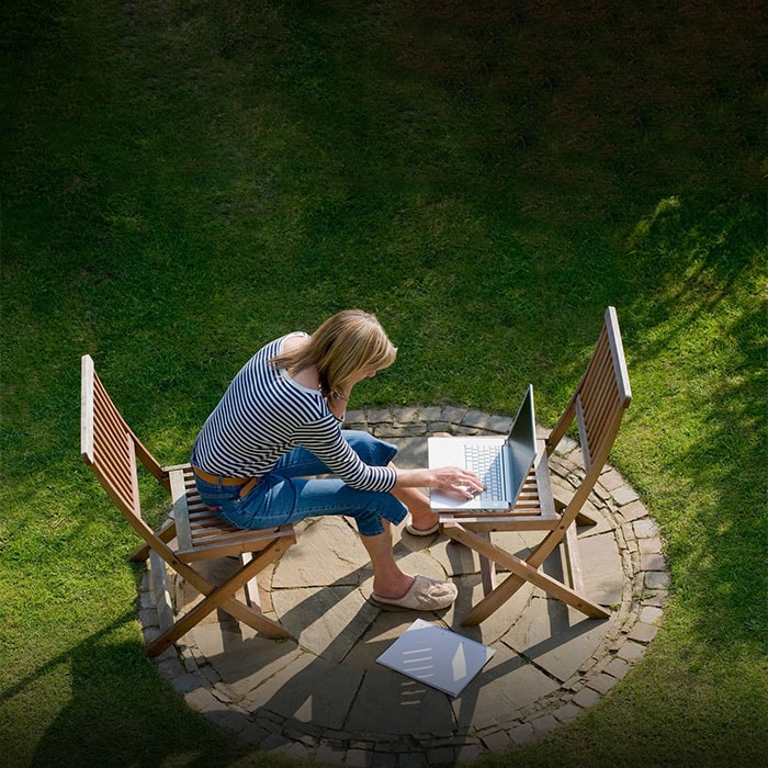 Woman outside on her laptop