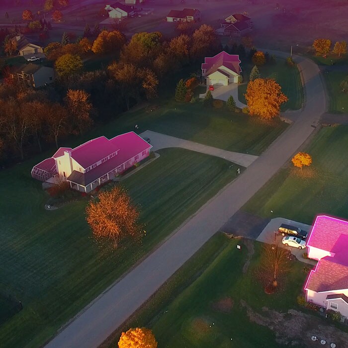 Rural homes with glowing magenta roofs